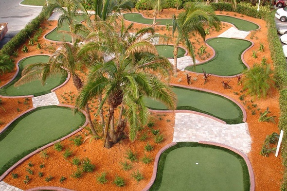 Augusta Aerial view of a mini golf course with synthetic grass and palm trees.